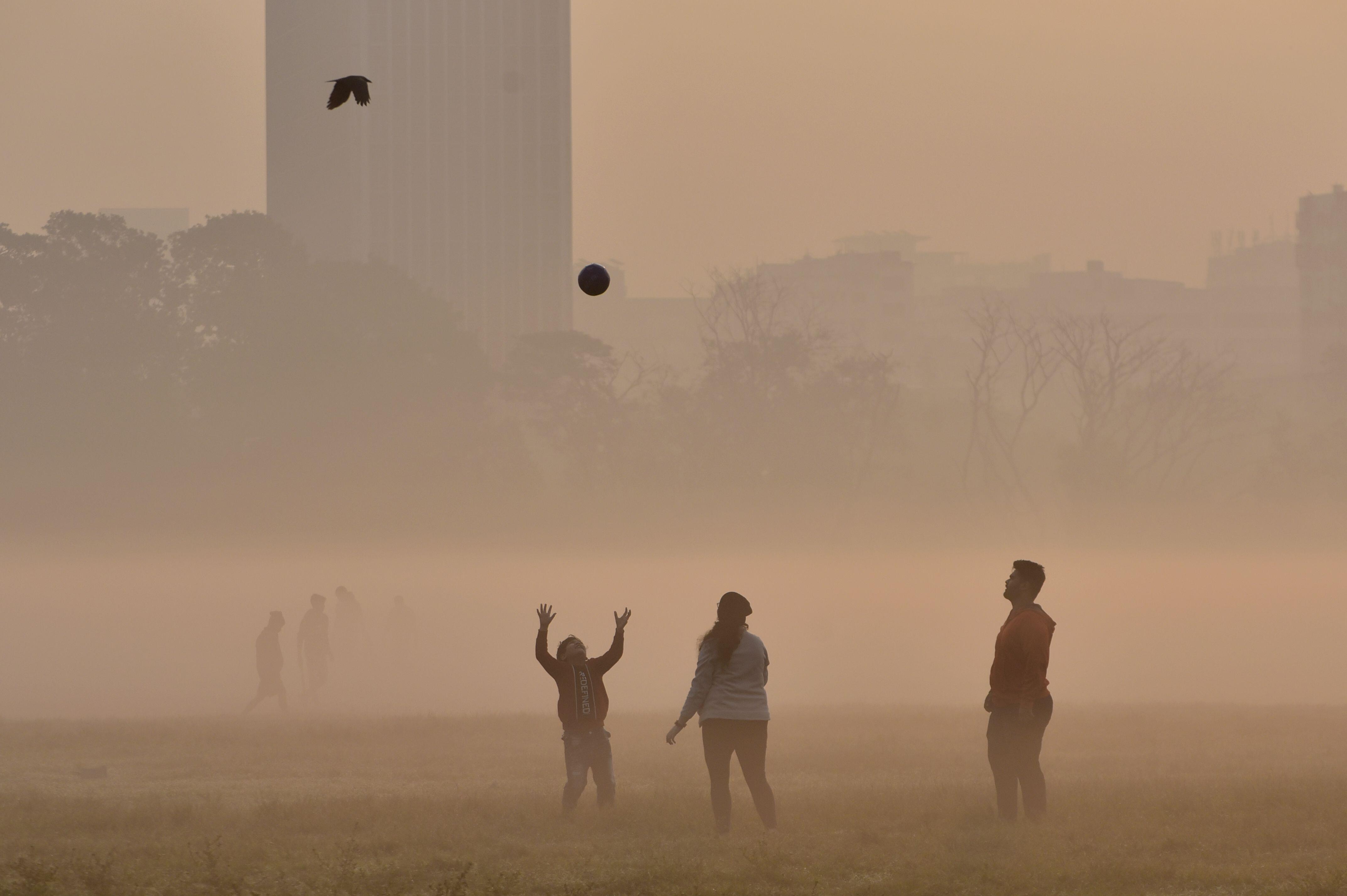 A Child Plays With A Ball Through The Dense Smog In Kolkata, India, Photo By Indranil Aditya/NurPhoto