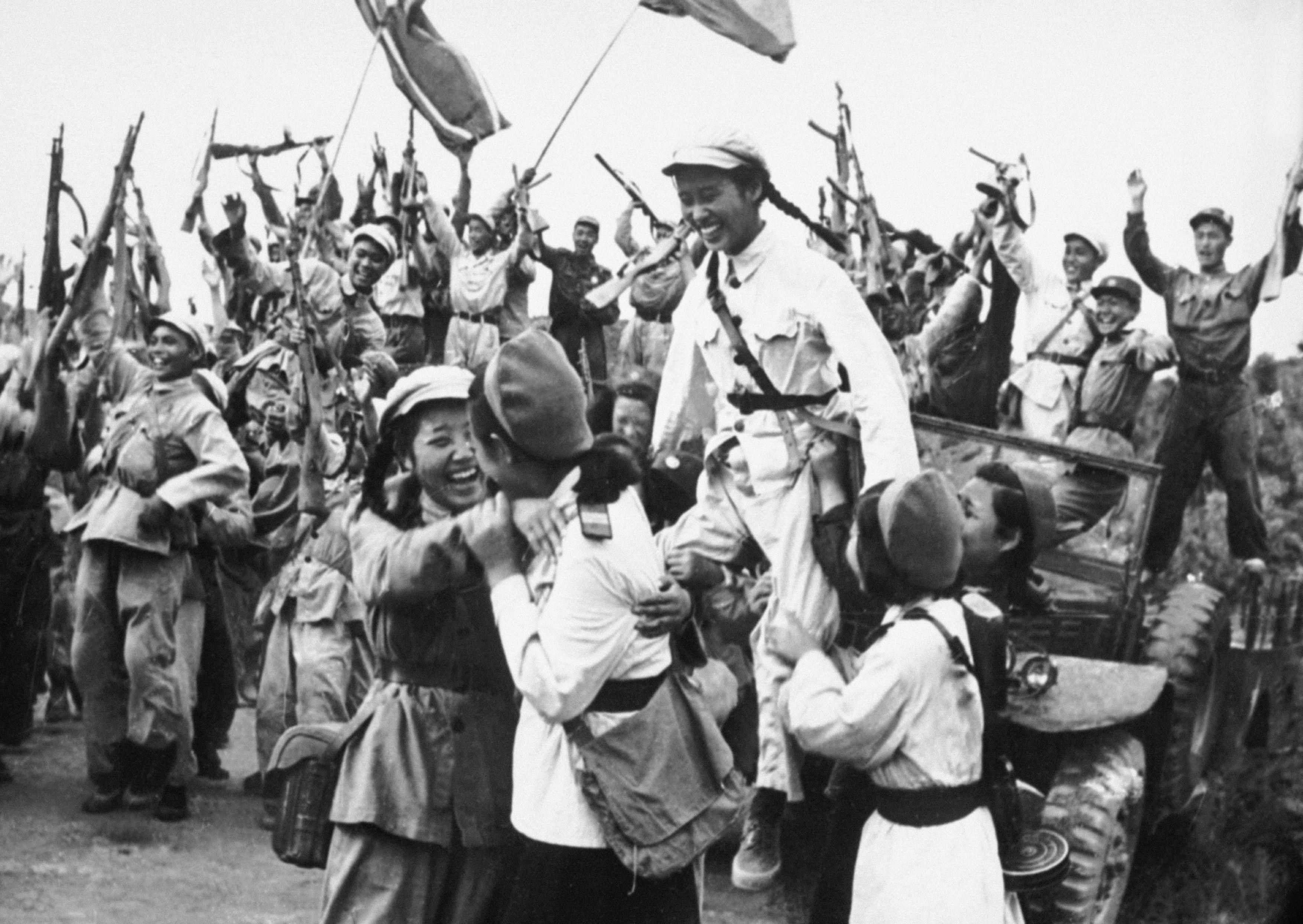 North-Korean and Chinese troops celebrate their shared victory in South Korea after having driven back an attack of American forces in June 1950. /Getty Images
