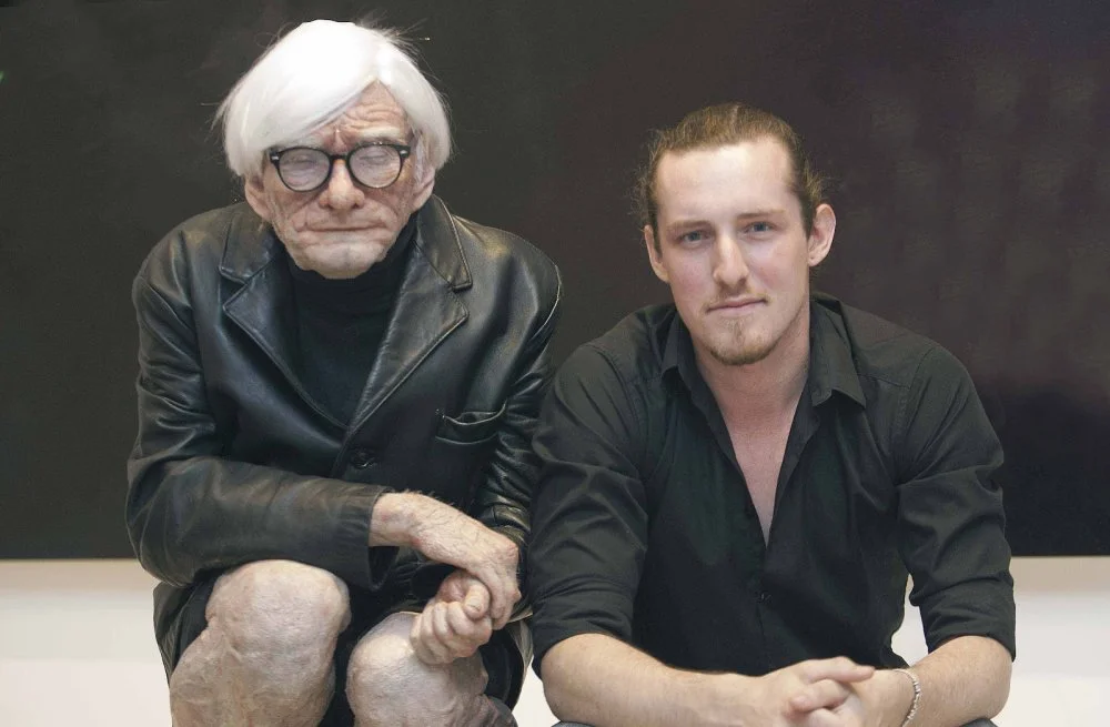 BIRMINGHAM, UNITED KINGDOM - AUGUST 03: Artist Edgar Askelovic poses with his sculpture of Andy Warhol at the Art Box Gallery on August 3, 2011 in Birmingham, England/Photo by Jack Mitchell/Getty Images