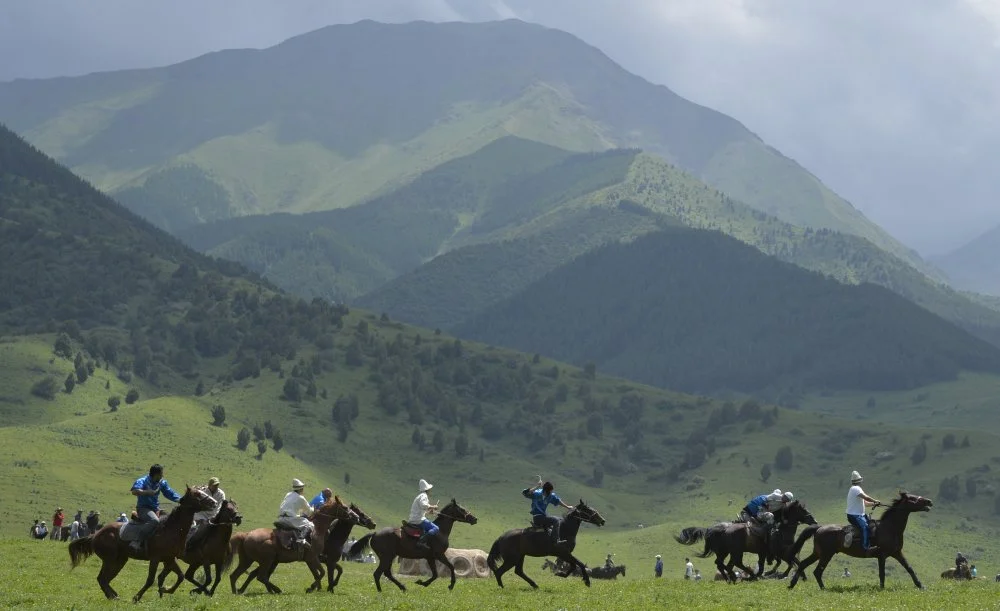 Mounted Kyrgyz riders play the traditional central Asian sport Kok-boru, know also as Buzkashi or Ulak Tartis ("goat grabbing"), during a folk festival at Kyrgyzstan's Chon-Kurchak valley, some 30km outside Bishkek, on June 17, 2017/VYACHESLAV OSELEDKO/AFP via Getty Images