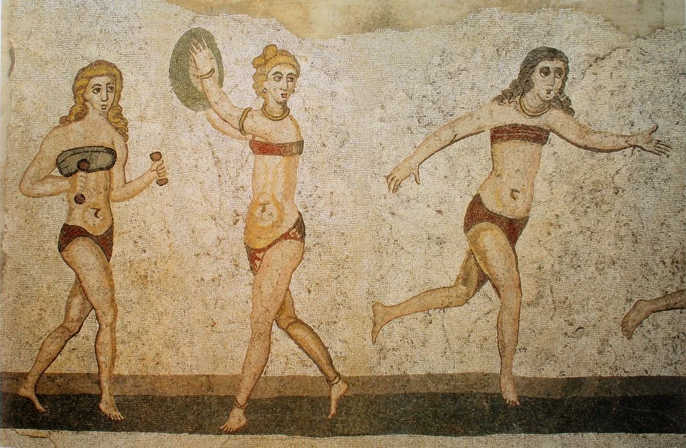 Roman women playing with a ball in a mosaic at Villa Romana del Casale. One of the so-called 'Bikini Mosaics', 4th century CE/Wikimedia Commons