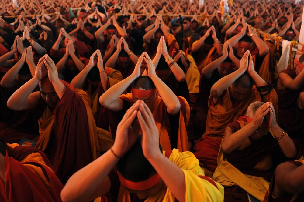 Buddhist monks wear red bandanas during special 'Avalokesteshvara Initiation' prayers during the fourth day of a teaching session led by Tibetan spiritual leader The Dalai Lama at The Kalachakra Ground near The Mahabodhi Temple in Bodhgaya on January 8, 2010. Exiled Tibetan spiritual leader The Dalai Lama is spending a week in the eastern Indian city where Buddha attained enlightenment, where he will pray and deliver teachings to followers/ DIPTENDU DUTTA/AFP via Getty Images