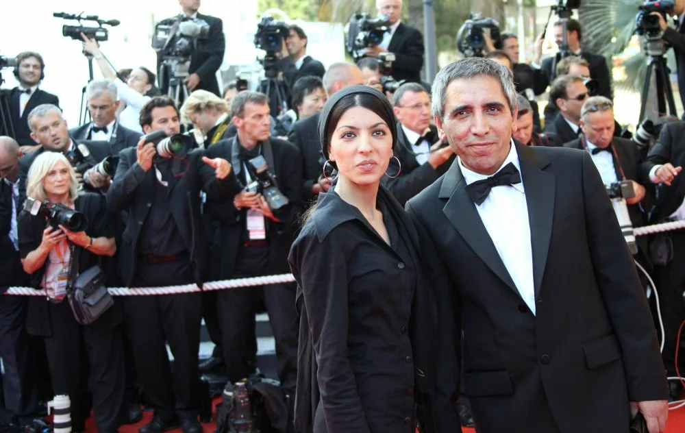 Iranian director Samira Makhmalbaf  and her father writer and director Mohsen Makhmalbaf pose 20 May 2007 upon arriving at the Festival Palace in Cannes for the screening of the collective film “To Each His Own Cinema” at the 60th edition of the Cannes Film Festival/ Anne-Christine Poujoulat /AFP via Getty Images