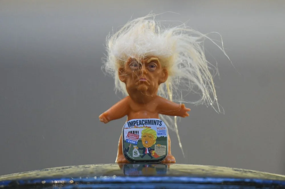 A box of Impeachmints, peach flavored mints referring to US President Donal Trump, seen in front of a vinyl doll of President Trump (made by a former sculptor for Disney Chuck Williams), on display at Dublin's Balla Ban Art Gallery. US President Donald Trump has been impeached by the Democratic-led House of Representatives for obstruction of Congress and abuse of power related to his dealings with Ukraine. On Thursday, 19 December 2019, in Dublin, Ireland/Artur Widak/NurPhoto/Getty Images