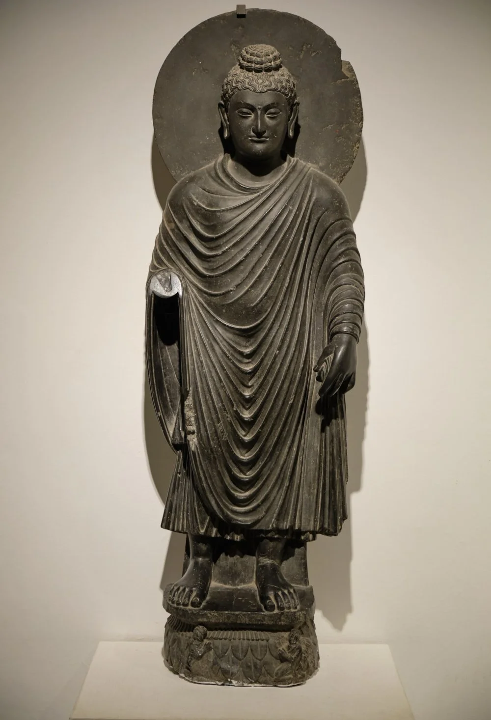 A greco-buddhist statue of a standing Buddha. The National Museum of India in New Delhi, India. 2nd century AD/Shutterstock