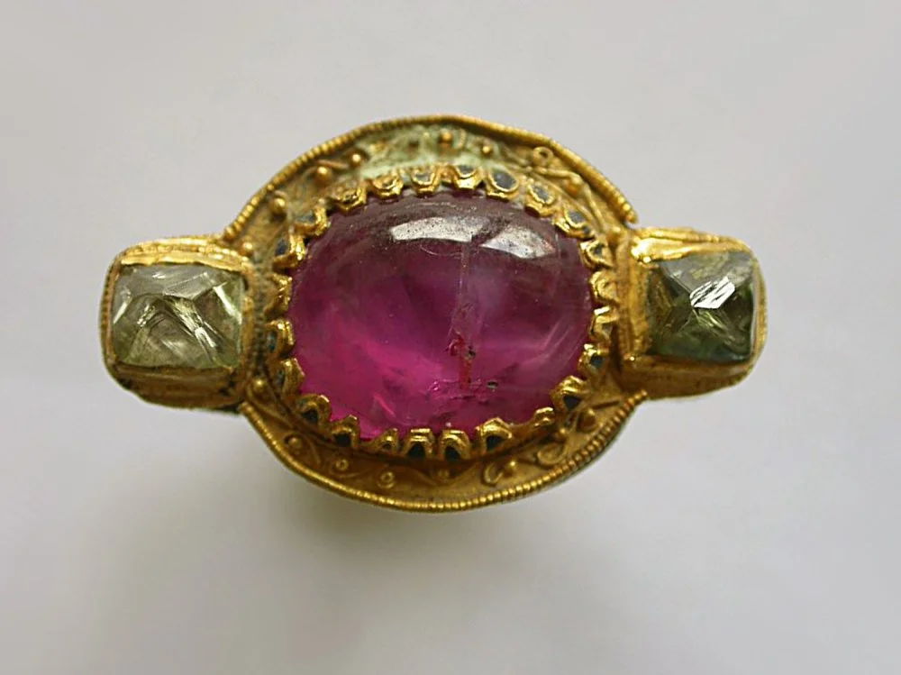 A 2,300 year old enameled gold ring, set with a pink sapphire cabochon and two rough diamonds, approximately 300 BC, Afghanistan/Pakistan region/from open access