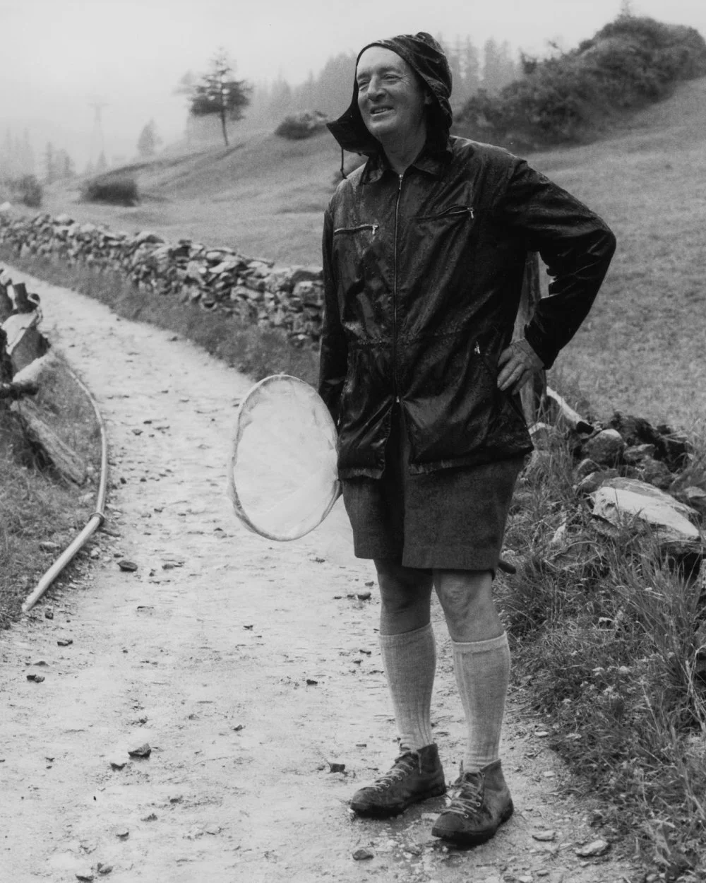 Vladimir Nabokov (1899 - 1977) carrying a net while hunting for butterflies in the rain, Zermatt, Switzerland/Horst Tappe/Getty Images