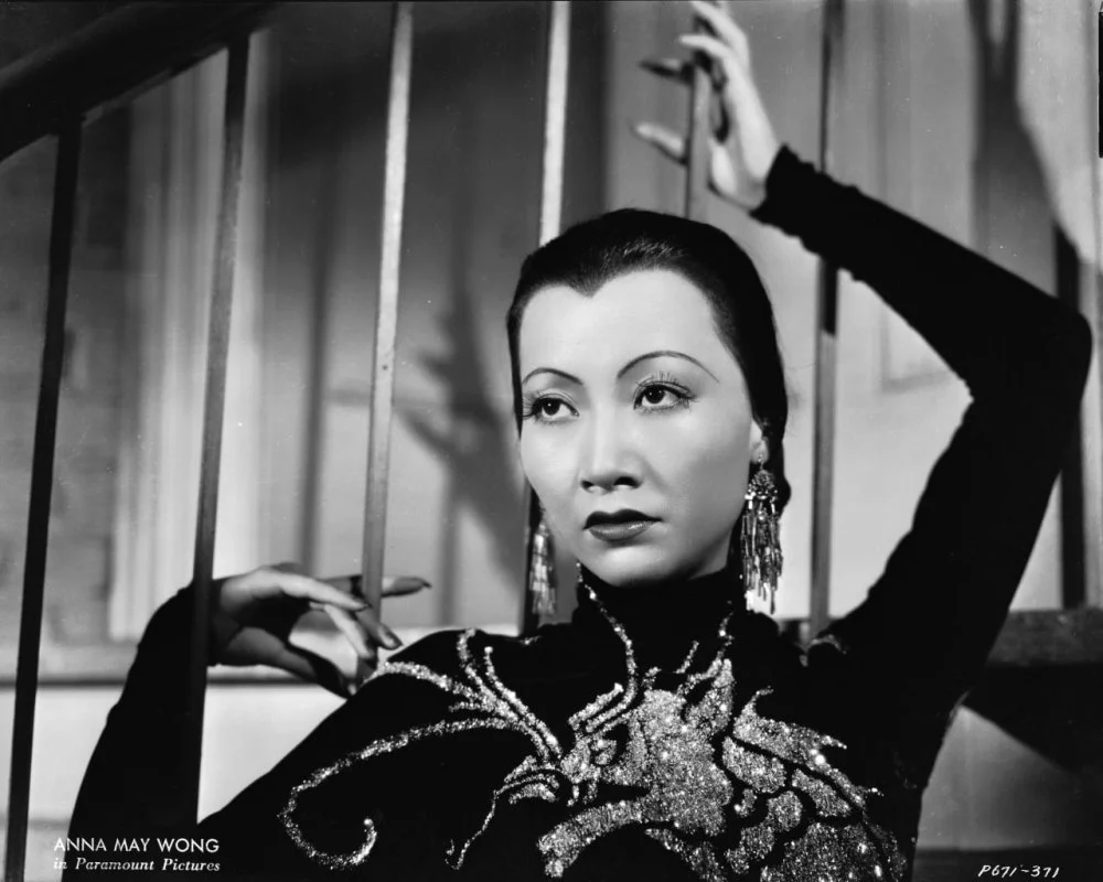 1934: Chinese-American film star, Anna May Wong (1905 - 1961) wearing a dress with a dragon motif in a publicity shot for 'Limehouse Blues', directed by Alexander Hall/John Kobal Foundation/Getty Images