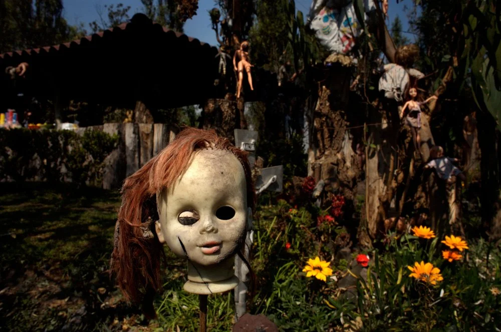 A doll hangs on a fence on the Island of the Dolls in Xochimilco, southern Mexico City/Alamy