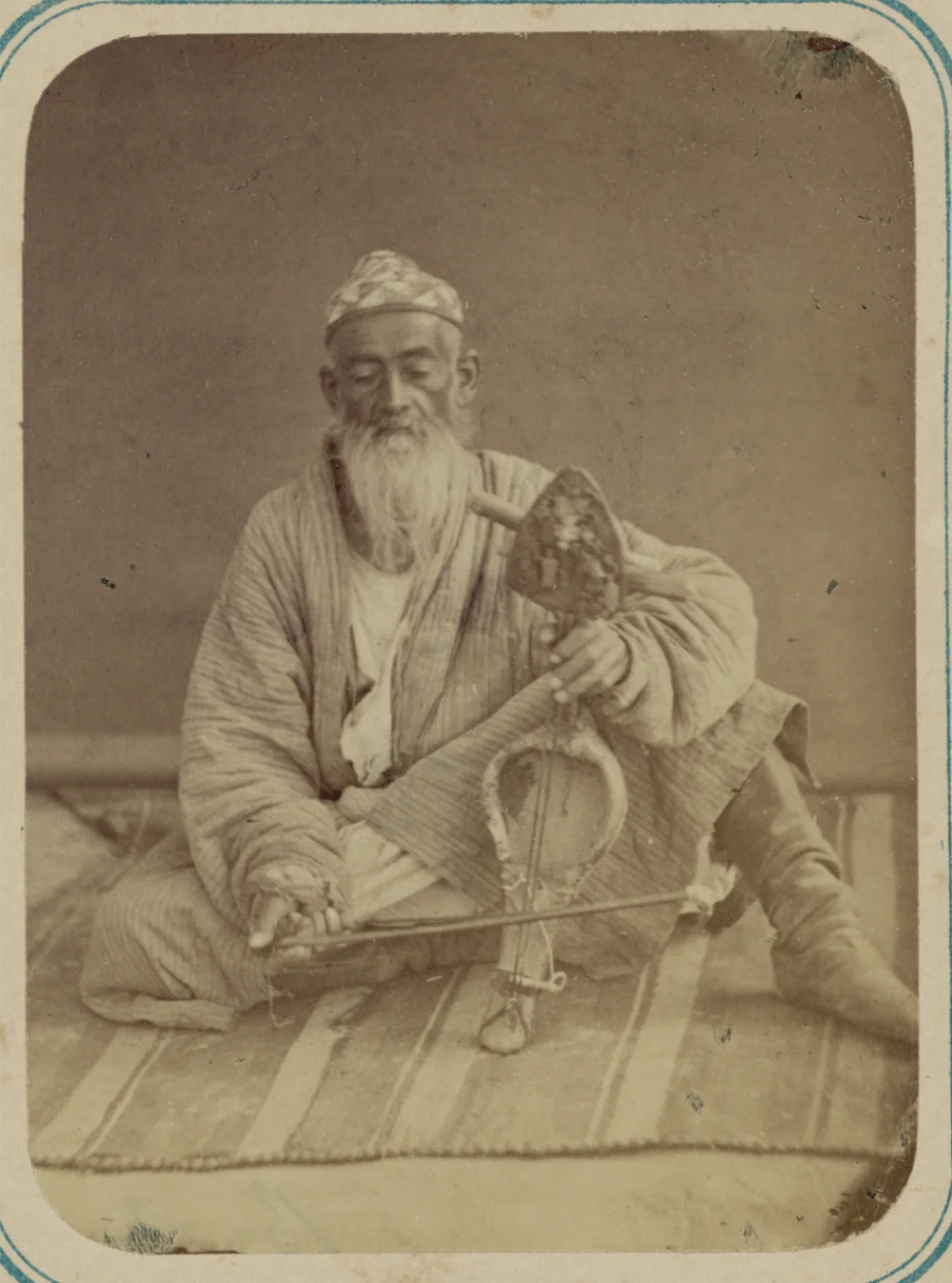 Pastimes of Central Asians. A Musician Playing a Kobyz/Kauz. This photograph is from the ethnographical part of the Turkestan Album. Between 1865 and 1872/Wikimedia commons