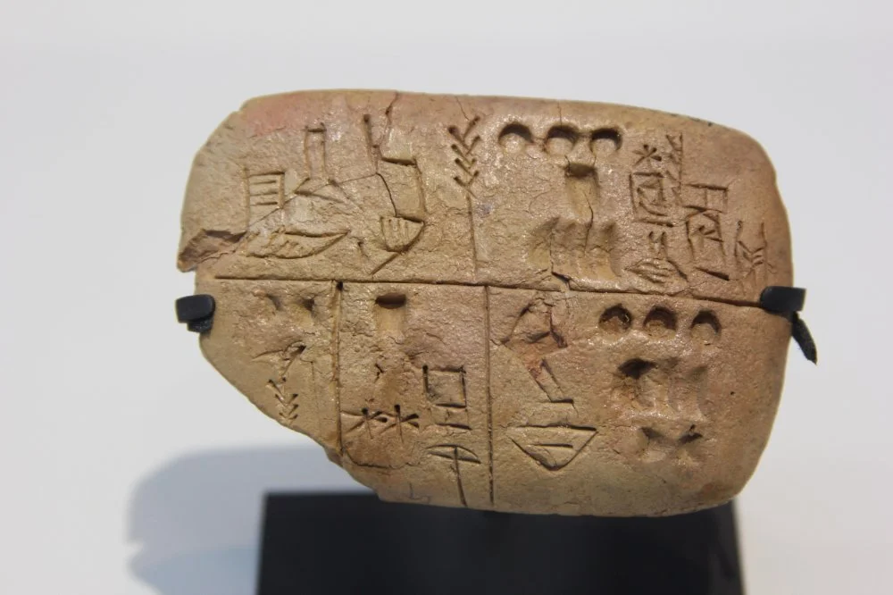 Pre-cuneiform writing clay tablet noting food rations. Archives of the Temple of the Sky God. Around 3300 BC. The Louvre Museum/shutterstock