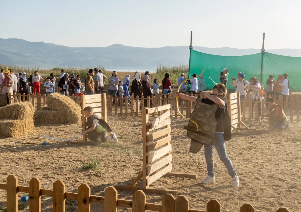 Kids practicing archery at Fourth World Nomad Games in Iznik, Turkey/Alamy