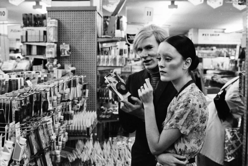 Jane Forth and Andy Warhol shopping for cosmetics, 1970/Photo by Jack Mitchell/Getty Images