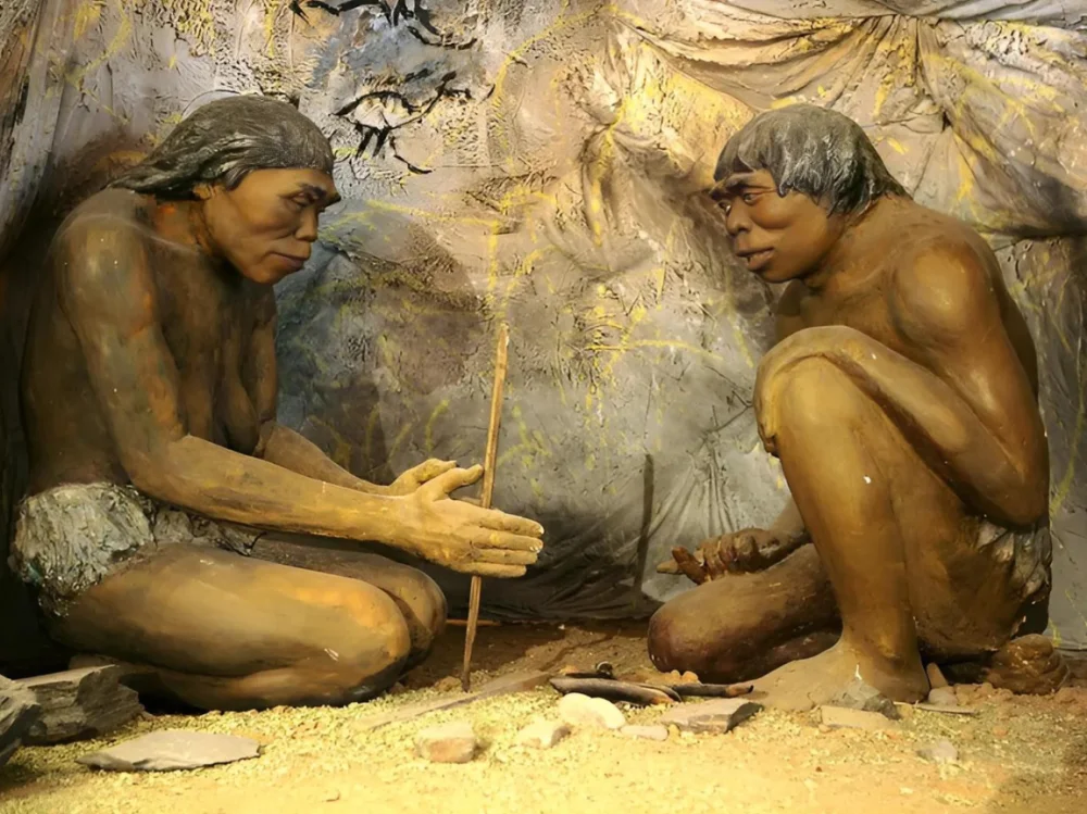 Figures of Stone Age hominids making tools at the National Museum of Mongolian History/Wikimedia Commons 