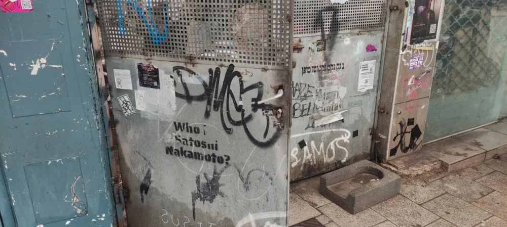 Who is Satoshi Nakamoto? Graffiti in Tel Aviv /Wikimedia Commons