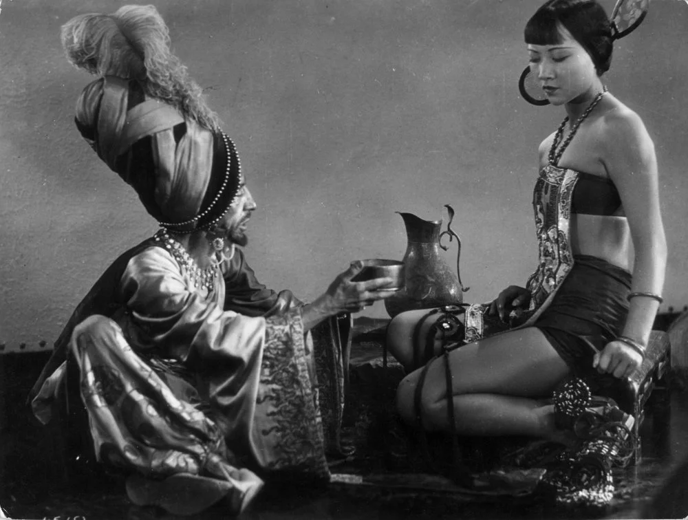 1924: The evil associate played by Snitz Edwards discusses the Princess with Anna May Wong in 'The Theif Of Bagdad' a flamboyant silent film which borrows from the arabian nights tales. Directed by Raoul Walsh for Douglas Fairbank's studio/Getty Images