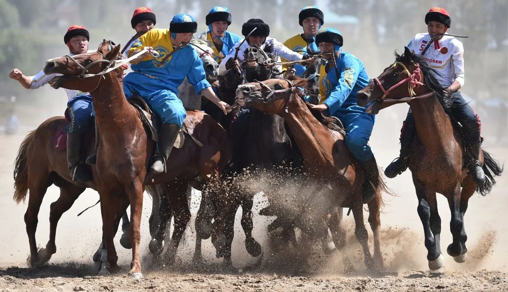 Russian (white) and Kazakh (blue) riders play the traditional Central Asian sport Buzkashi also known as Kok-Boru or Oglak Tartis during the World Nomad Games 2018 in Cholpon-Ata, eastern Kirghizstan, on September 5, 2018/Getty Images