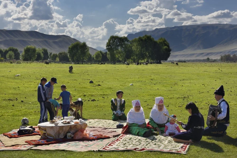 Picnic with family in traditional clothes singing in Saty pastureland on the Chilik river Kazakhstan/Education Images/Universal Images Group via Getty Images