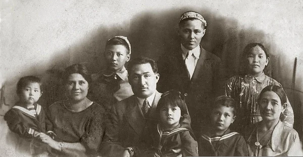  On May 3, 1937. On the left, Fatima Gabitova with little Ilfa Zhansugurova in her arms. In the center, Ilyas Zhansugurov holds Umut's daughter in his arms, and Azat Suleev sits to Umut's right. Janibek Suleev stands between Fatima and Ilyas. On the far right is Huppizhamal, Fatima Gabitova's maternal aunt. A housekeeper (name unknown) is standing over her. Ilyas's nephew Bulatkhan is standing to her left/From open sources 